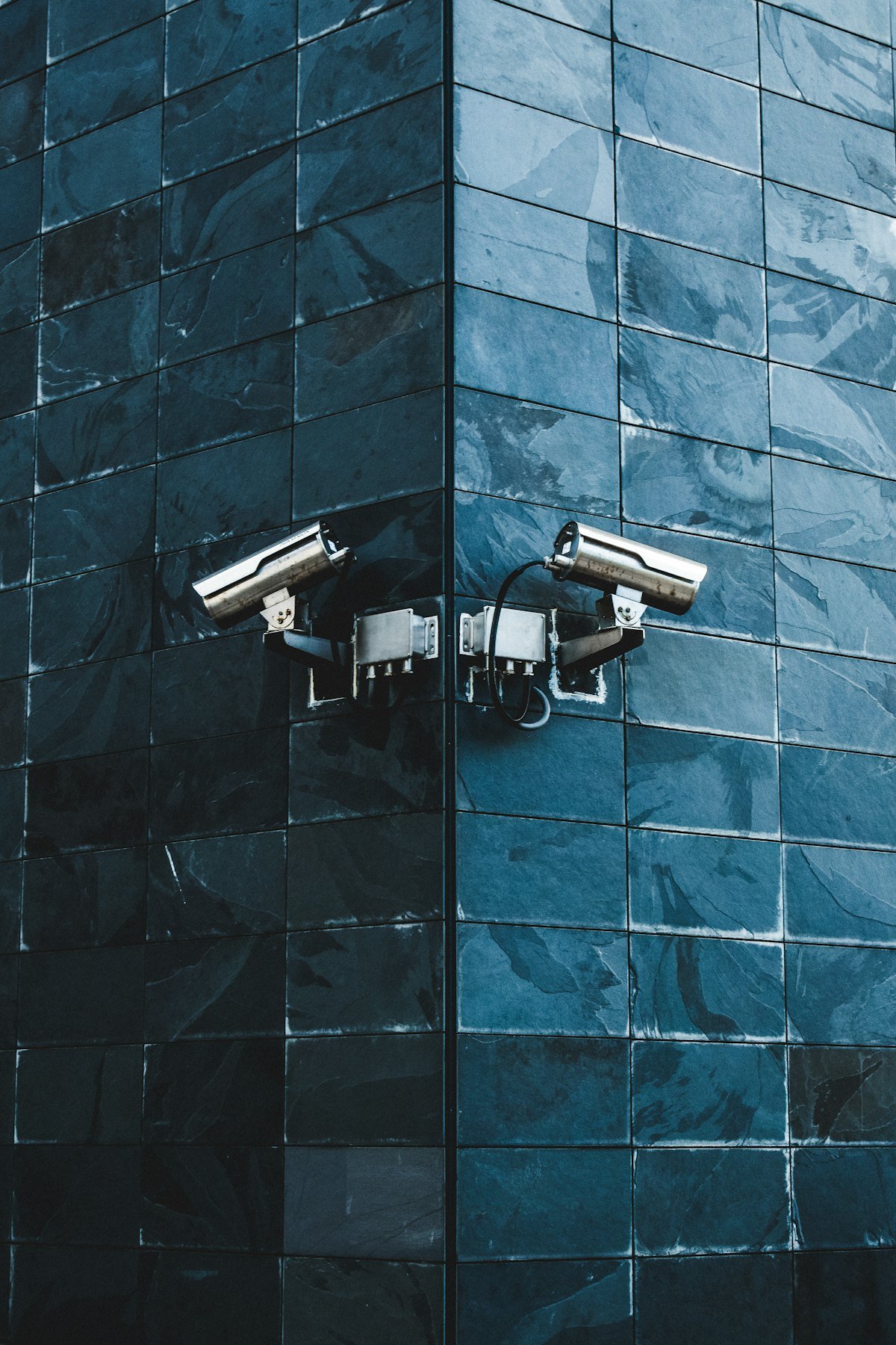 Cameras covering an entrance on a tiled facade